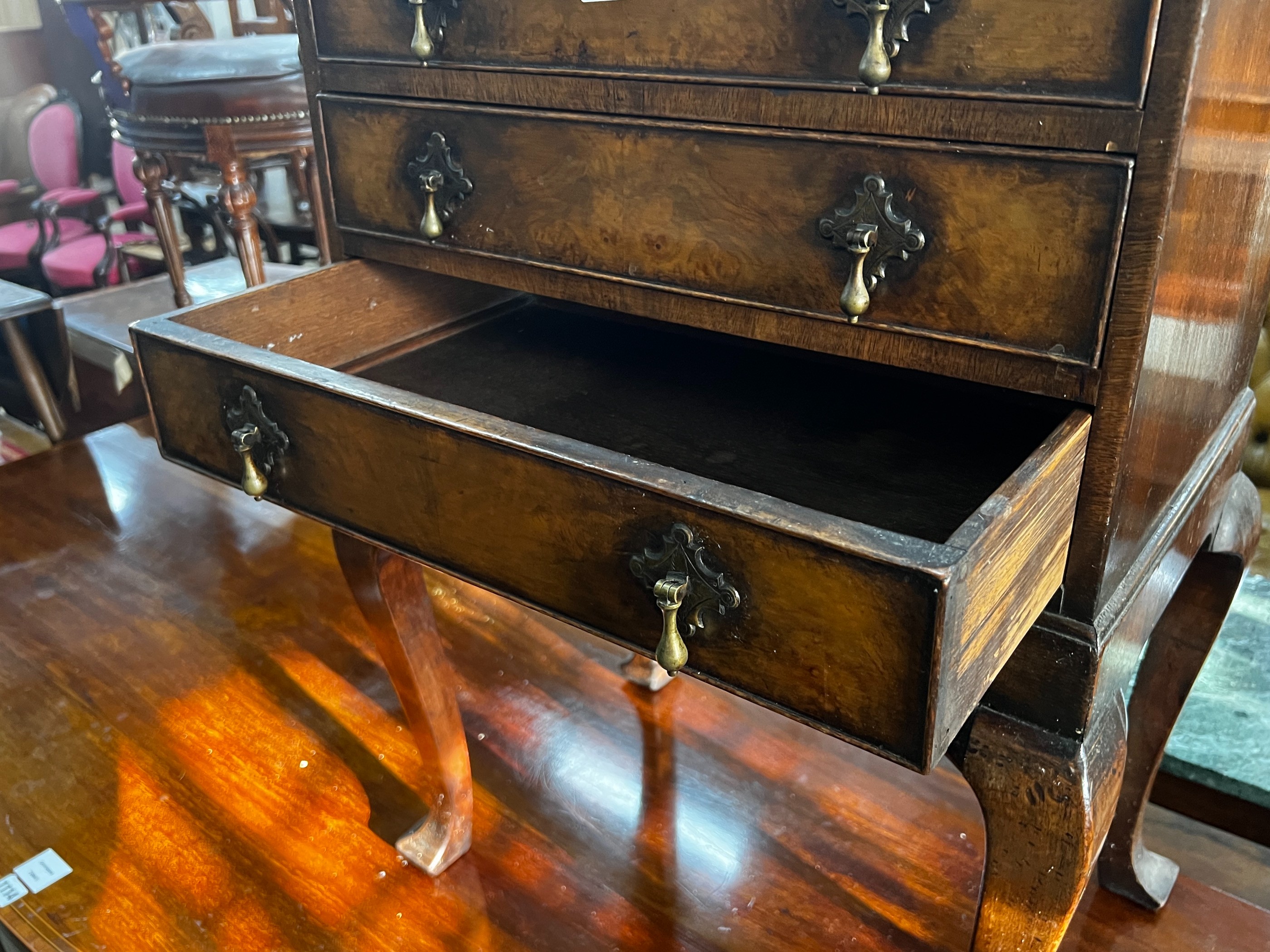 A George III style walnut bedside chest, fitted three long drawers, width 53cm, depth 39cm, height 75cm